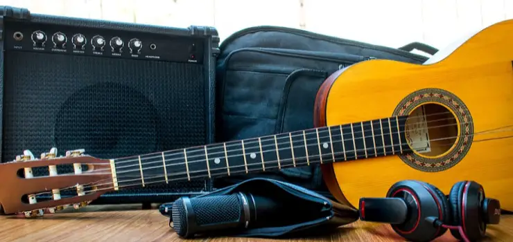 an amplifier and an acoustic guitar on the floor
