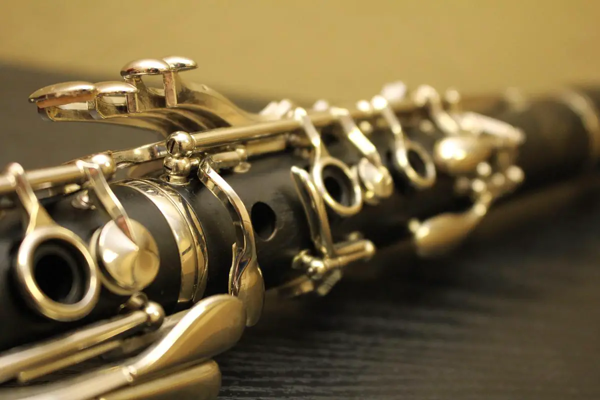 A close-up image of a clarinet showcasing the finger positioning for the lowest note.
