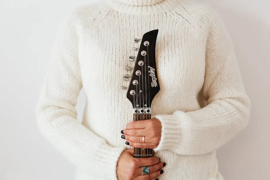 Image depicting a person performing finger stretches on a guitar fretboard
