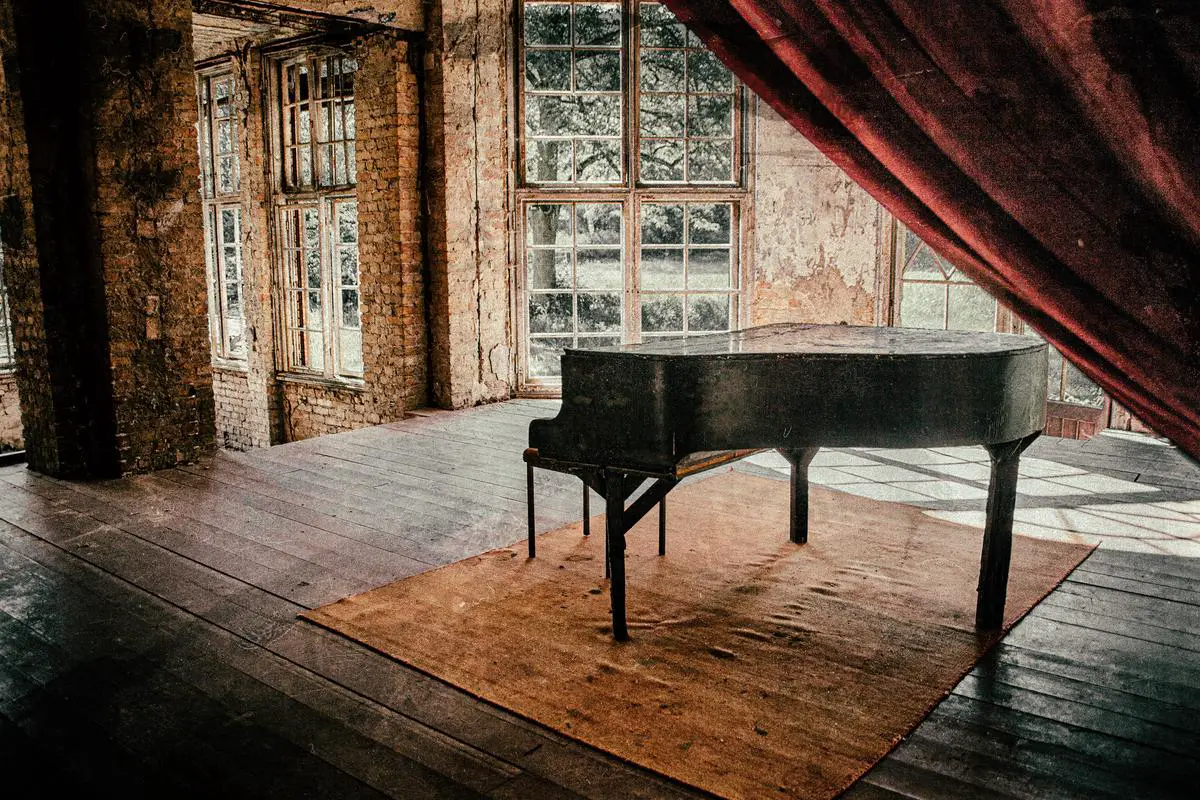 A grand piano in a dimly lit concert hall