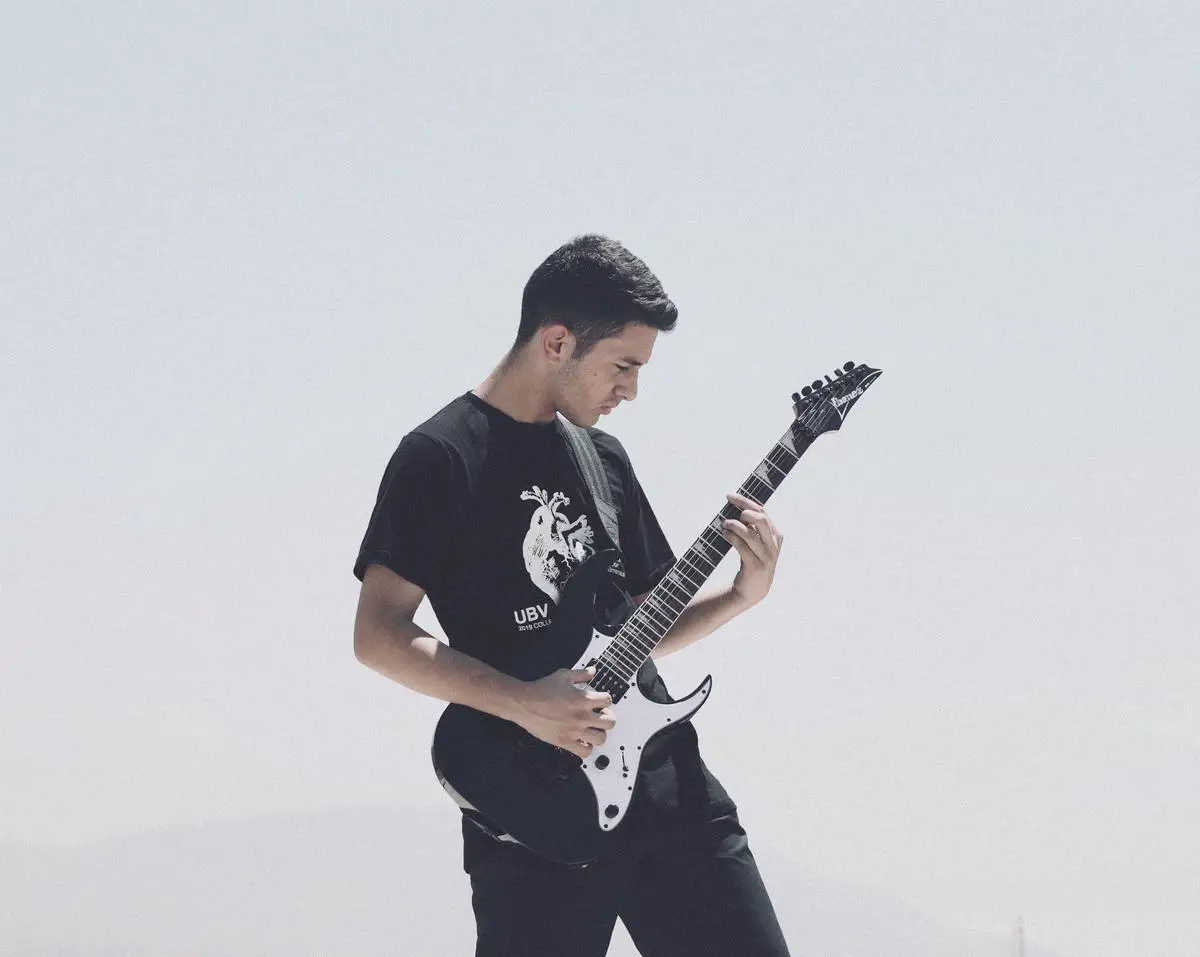 An image featuring a guitarist playing a guitar tuned in Open E tuning, capturing the vibrancy and depth of the sound.